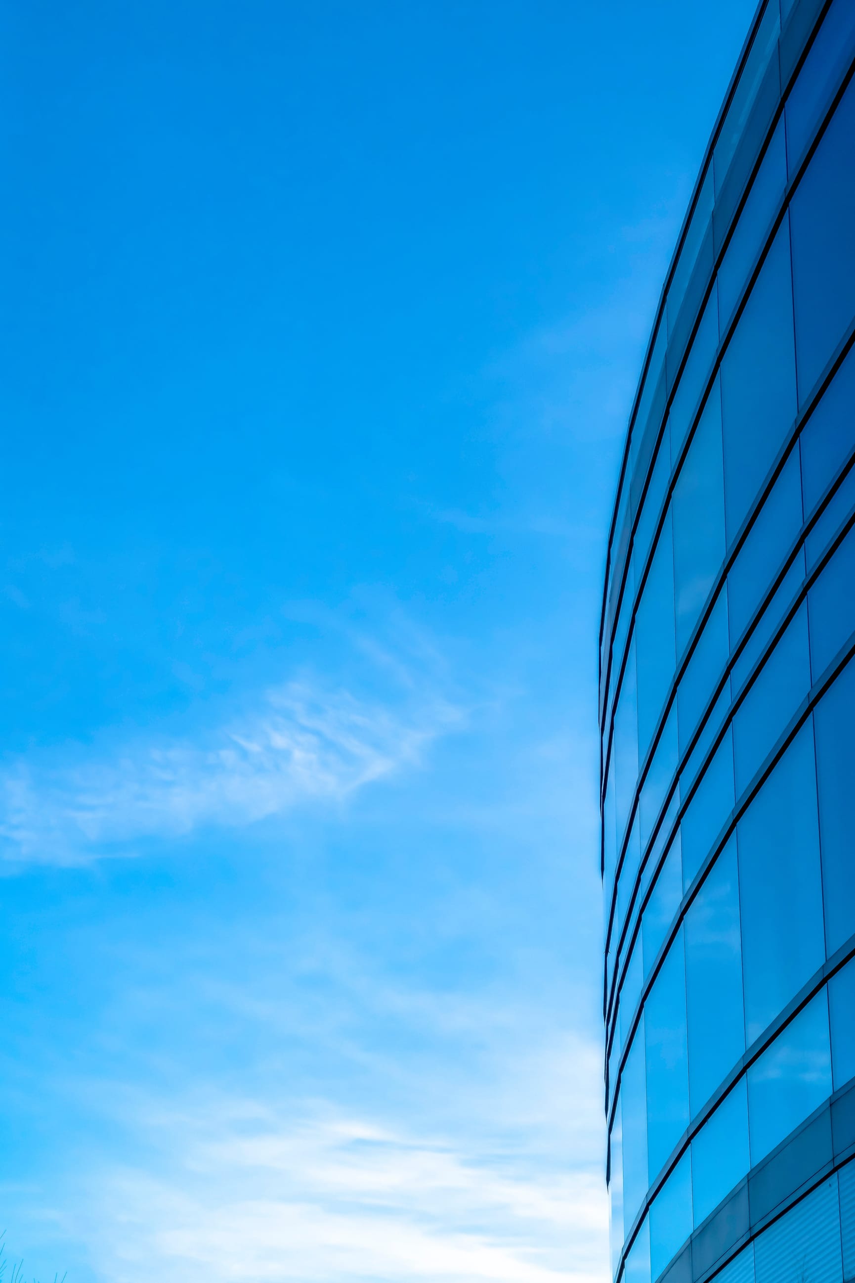 glass building in front of blue sky