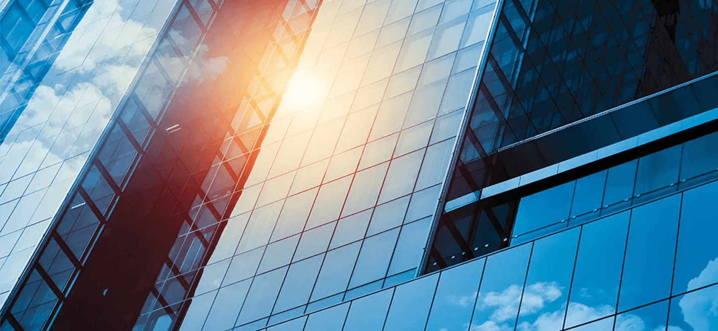 Glass high-rise building with sun reflection